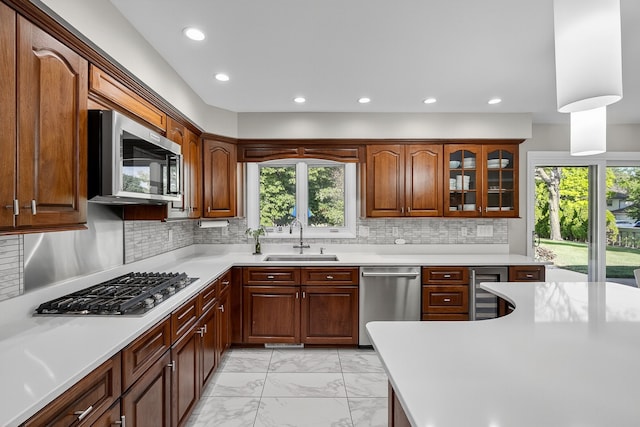 4130 Beaver Ave, Des Moines, IA 50310 - kitchen with appliances with stainless steel finishes, light marble finish flooring, beverage cooler, light countertops, and recessed lighting
