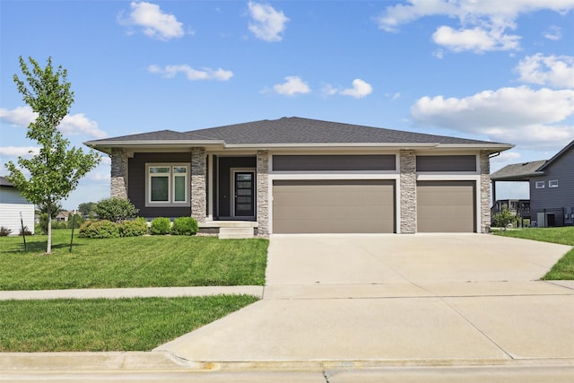 1824 Bentley Ct, Norwalk, IA 50211 - prairie-style house featuring driveway, a garage, a front lawn, and stone siding