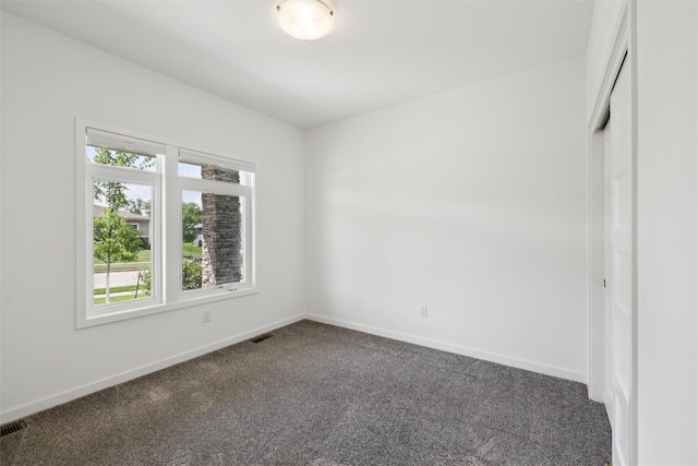 1824 Bentley Ct, Norwalk, IA 50211 - spare room featuring dark colored carpet and baseboards