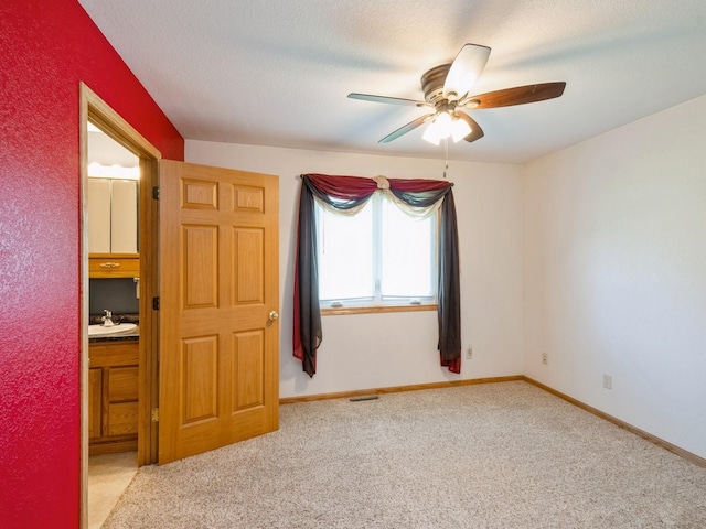 815 W 6th St S, Newton, IA 50208 - carpeted empty room featuring a ceiling fan and baseboards