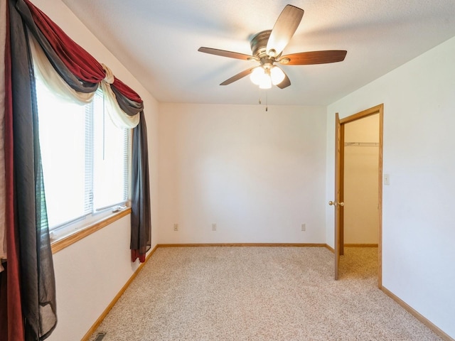 815 W 6th St S, Newton, IA 50208 - spare room with light carpet and a ceiling fan