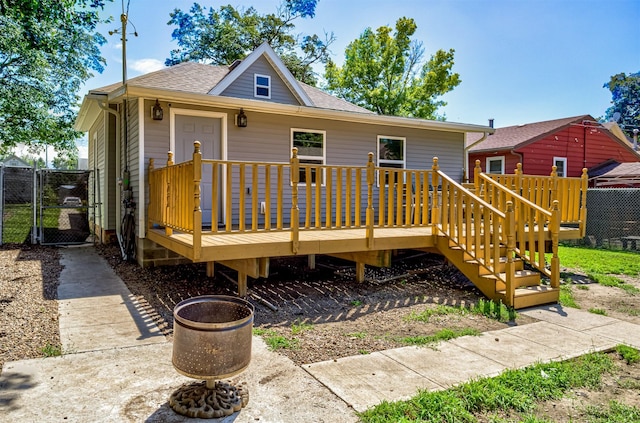 1718 Otley Ave, Perry, IA 50220 - rear view of house with a gate, a deck, and a shingled roof