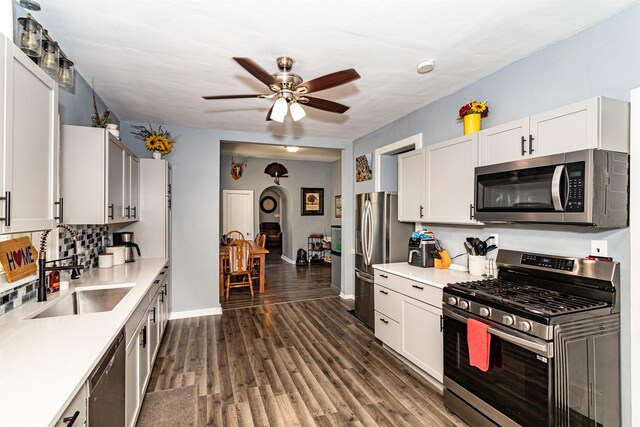 1718 Otley Ave, Perry, IA 50220 - kitchen with appliances with stainless steel finishes, a ceiling fan, light countertops, and white cabinets