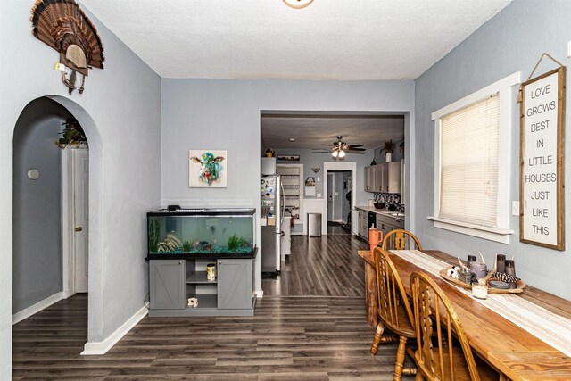 1718 Otley Ave, Perry, IA 50220 - dining space featuring dark wood-type flooring, a ceiling fan, arched walkways, and a textured ceiling