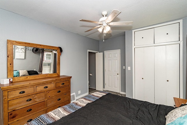 1718 Otley Ave, Perry, IA 50220 - bedroom with a closet, a textured ceiling, and ceiling fan