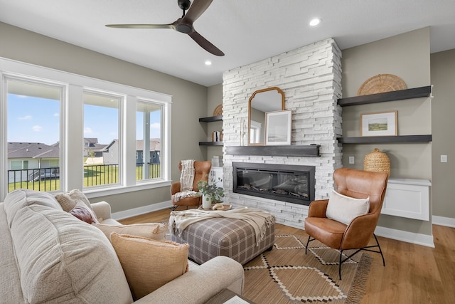 17736 Hammontree Dr, Clive, IA 50325 - living room with ceiling fan, a stone fireplace, wood finished floors, and recessed lighting