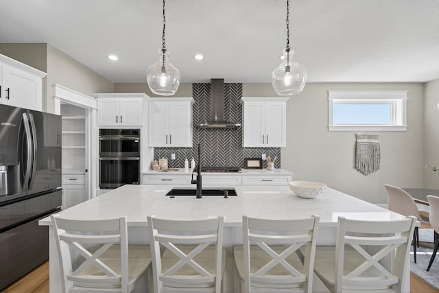 17736 Hammontree Dr, Clive, IA 50325 - kitchen with wall chimney range hood, refrigerator with ice dispenser, backsplash, a kitchen island with sink, and recessed lighting