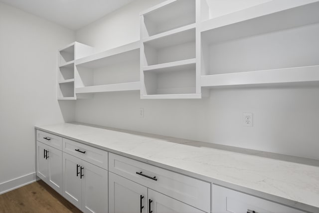 17736 Hammontree Dr, Clive, IA 50325 - kitchen with open shelves, light stone counters, white cabinetry, and dark wood-style floors