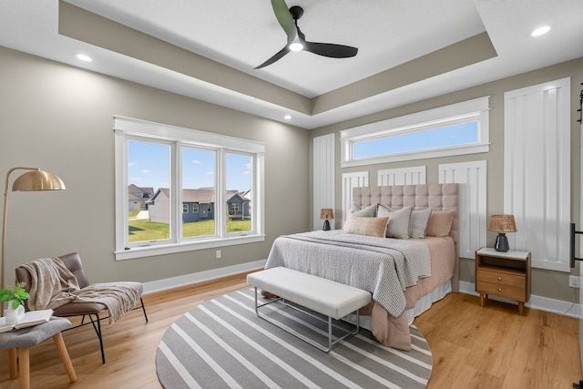 17736 Hammontree Dr, Clive, IA 50325 - bedroom with light wood-type flooring, recessed lighting, ceiling fan, and a raised ceiling