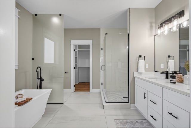 17736 Hammontree Dr, Clive, IA 50325 - full bath with a stall shower, vanity, a spacious closet, tile patterned floors, and a freestanding tub