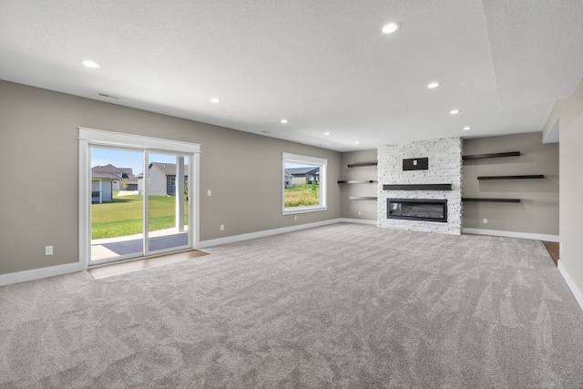17736 Hammontree Dr, Clive, IA 50325 - unfurnished living room featuring carpet flooring, recessed lighting, and a fireplace