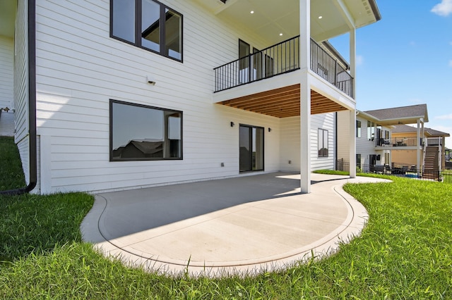 17736 Hammontree Dr, Clive, IA 50325 - back of house featuring a patio area, a yard, and a balcony