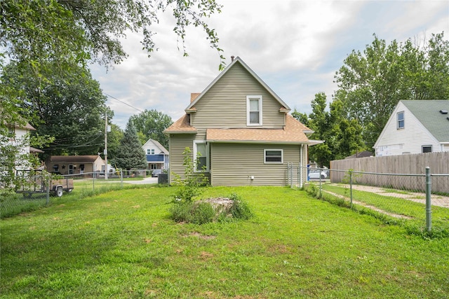 2124 E 23rd St, Des Moines, IA 50317 - back of property featuring a fenced backyard and a chimney