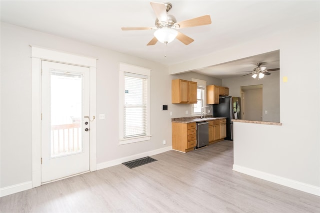 2124 E 23rd St, Des Moines, IA 50317 - kitchen with fridge with ice dispenser, stainless steel dishwasher, ceiling fan, and light wood-style floors