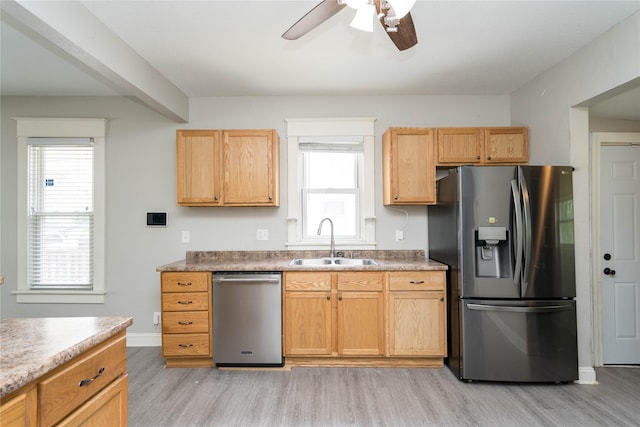 2124 E 23rd St, Des Moines, IA 50317 - kitchen featuring stainless steel appliances, light wood finished floors, a ceiling fan, and healthy amount of natural light