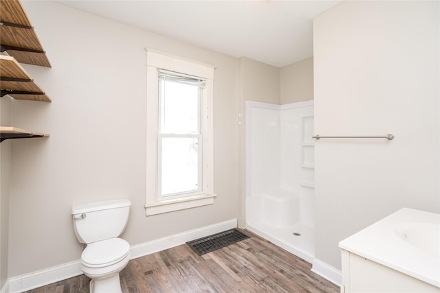 2124 E 23rd St, Des Moines, IA 50317 - full bathroom with wood finished floors, healthy amount of natural light, and vanity