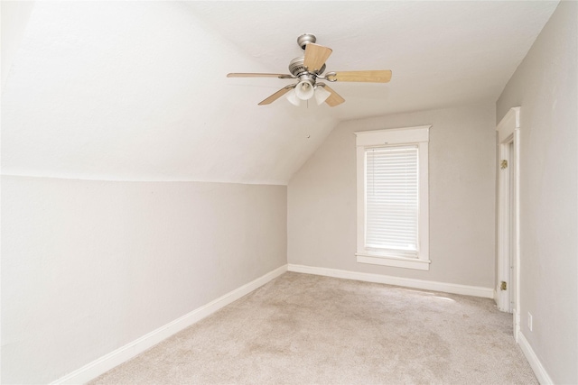 2124 E 23rd St, Des Moines, IA 50317 - additional living space with light carpet, lofted ceiling, and a ceiling fan