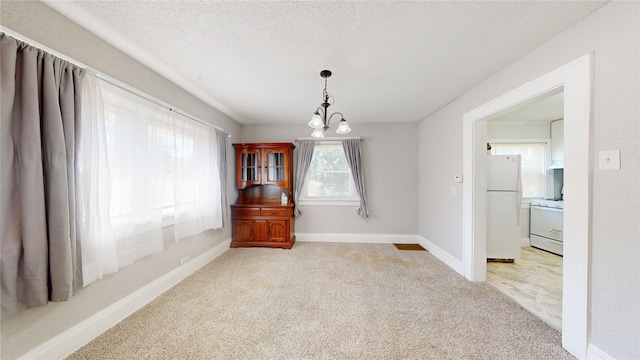 1725 Mondamin Ave, Des Moines, IA 50314 - unfurnished dining area featuring carpet and a textured ceiling