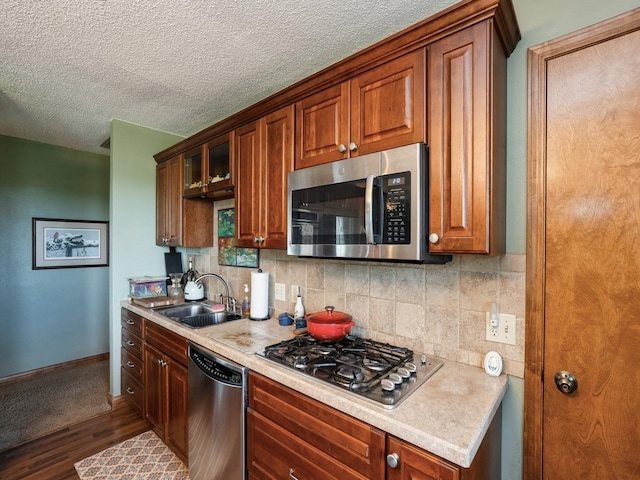1246 N 75th Ave W, Newton, IA 50208 - kitchen featuring appliances with stainless steel finishes, dark wood-style flooring, light countertops, tasteful backsplash, and a textured ceiling