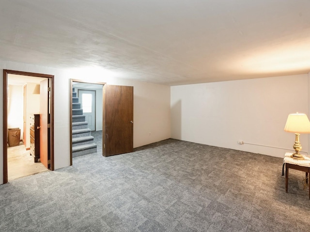 1246 N 75th Ave W, Newton, IA 50208 - carpeted spare room featuring stairs