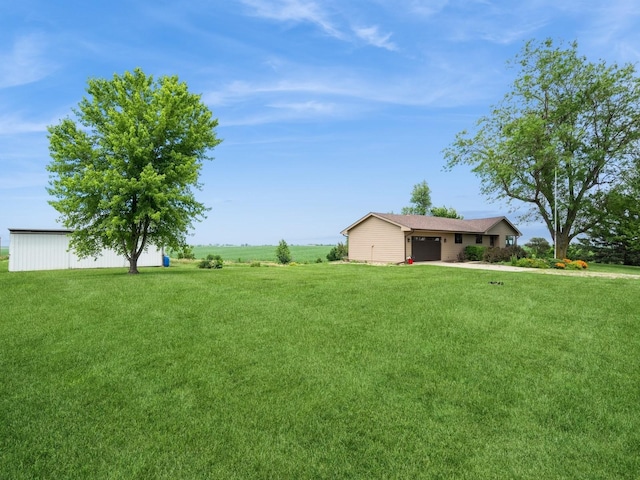 1246 N 75th Ave W, Newton, IA 50208 - view of green lawn with a garage
