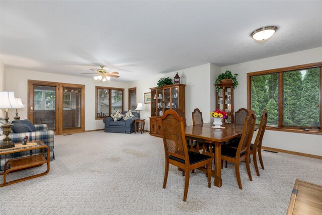 1412 Court St, Adel, IA 50003 - dining area with plenty of natural light, light carpet, and a ceiling fan