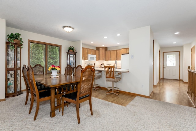 1412 Court St, Adel, IA 50003 - dining space with recessed lighting, light wood-style floors, and light colored carpet