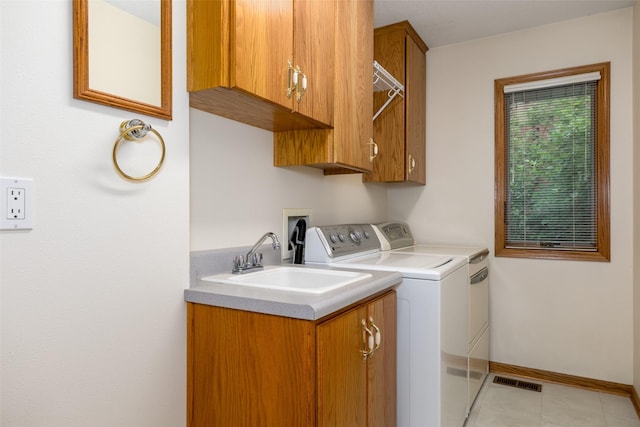 1412 Court St, Adel, IA 50003 - laundry room with separate washer and dryer, cabinet space, and light tile patterned flooring