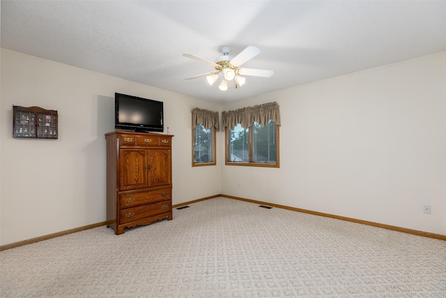 1412 Court St, Adel, IA 50003 - unfurnished bedroom featuring light carpet and a ceiling fan