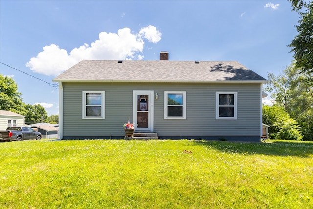 3851 E 25th St, Des Moines, IA 50317 - rear view of house with entry steps, a chimney, a yard, and roof with shingles