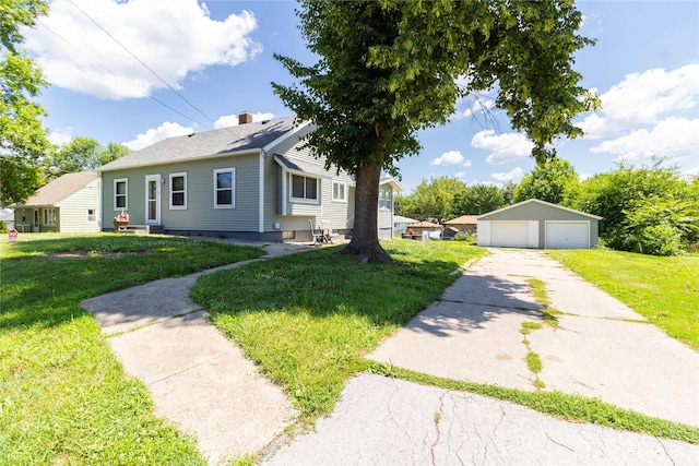 3851 E 25th St, Des Moines, IA 50317 - view of front of house featuring a detached garage, an outdoor structure, a front yard, and a chimney