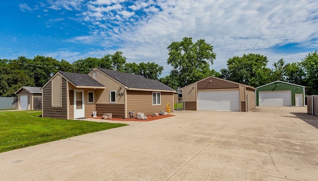 401 NW 50th Pl, Des Moines, IA 50313 - view of front facade featuring a garage and an outbuilding