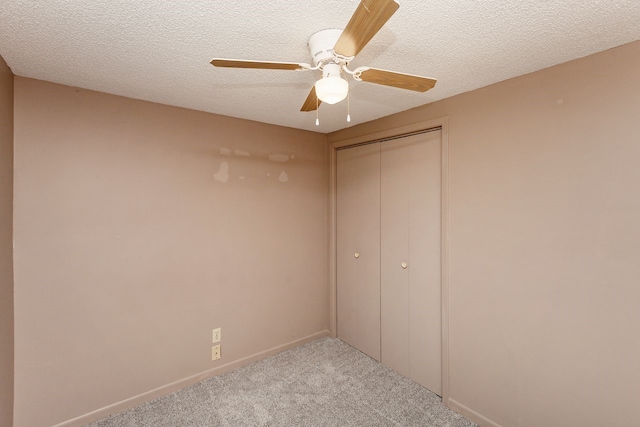 401 NW 50th Pl, Des Moines, IA 50313 - unfurnished bedroom with carpet flooring, a closet, ceiling fan, and a textured ceiling