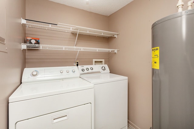 401 NW 50th Pl, Des Moines, IA 50313 - laundry area featuring water heater, separate washer and dryer, and a textured ceiling