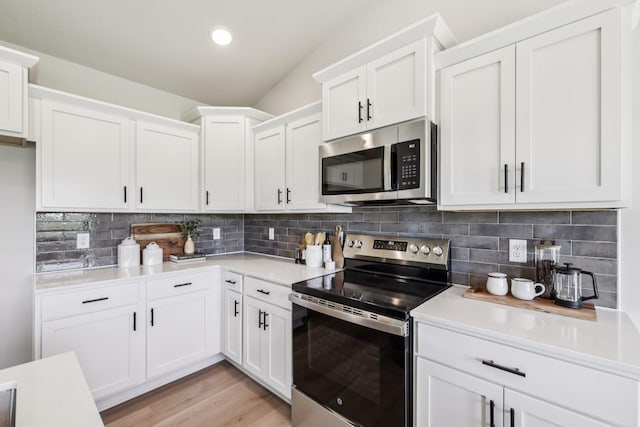 4422 NW Olivia Ln, Ankeny, IA 50023 - kitchen featuring stainless steel appliances, light countertops, white cabinetry, decorative backsplash, and light wood-style floors