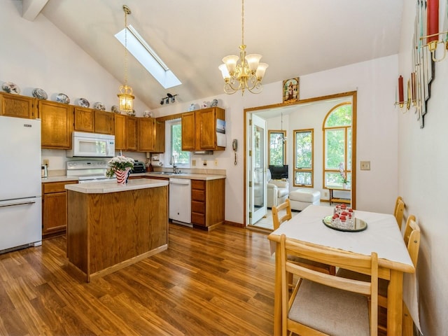 1907 Thornton Ct, Des Moines, IA 50320 - kitchen featuring white appliances, a skylight, light countertops, dark wood-type flooring, and brown cabinets