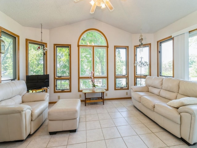 1907 Thornton Ct, Des Moines, IA 50320 - living room featuring ceiling fan, vaulted ceiling, light tile patterned floors, and plenty of natural light
