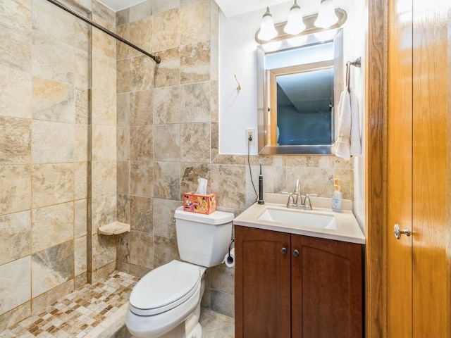 1907 Thornton Ct, Des Moines, IA 50320 - bathroom featuring vanity, tiled shower, and tile walls