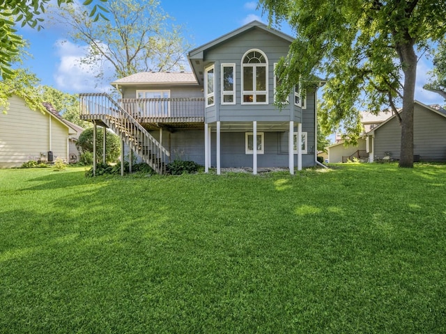 1907 Thornton Ct, Des Moines, IA 50320 - back of property featuring a lawn, stairway, and a wooden deck