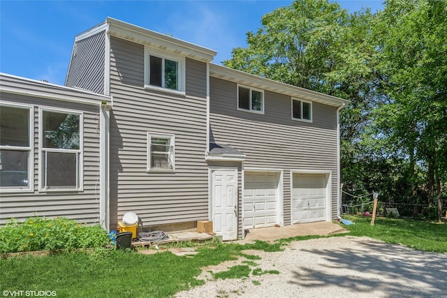 4131 55th St, Des Moines, IA 50310 - back of property with a garage and gravel driveway