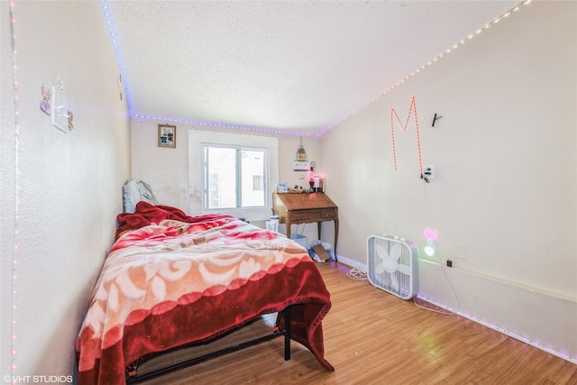 4131 55th St, Des Moines, IA 50310 - bedroom featuring wood finished floors and a textured ceiling