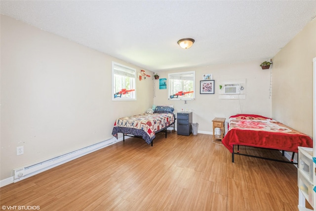 4131 55th St, Des Moines, IA 50310 - bedroom featuring light wood-type flooring and a baseboard radiator