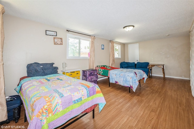 4131 55th St, Des Moines, IA 50310 - bedroom featuring light wood finished floors and a textured ceiling