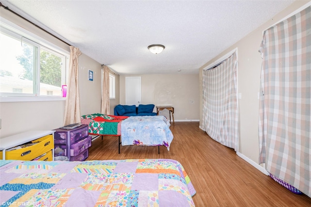 4131 55th St, Des Moines, IA 50310 - bedroom with light wood-style flooring and a textured ceiling