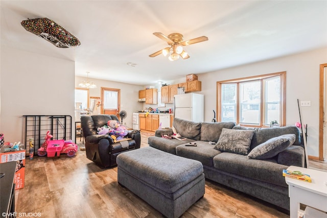 4131 55th St, Des Moines, IA 50310 - living room with healthy amount of natural light, light wood finished floors, a ceiling fan, and a chandelier