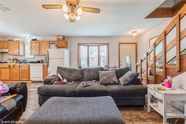 4131 55th St, Des Moines, IA 50310 - living room featuring a ceiling fan, wood finished floors, and stairway