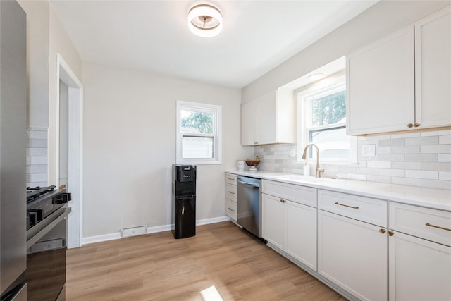 804 24th St, West Des Moines, IA 50265 - kitchen with stainless steel dishwasher, tasteful backsplash, light wood-style floors, and white cabinetry