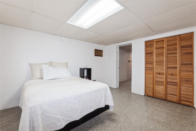 804 24th St, West Des Moines, IA 50265 - bedroom with a drop ceiling, concrete block wall, and a closet