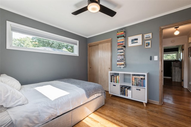 804 24th St, West Des Moines, IA 50265 - bedroom with wood finished floors, crown molding, a closet, and a ceiling fan