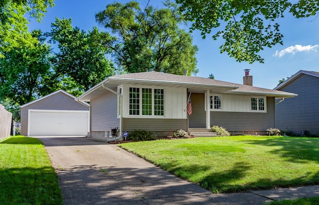 1022 Trisha Ave, Des Moines, IA 50313 - view of front of home with an outbuilding, a garage, a chimney, and a front lawn